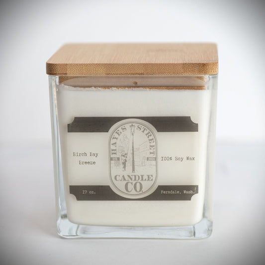 Birch Bay Breeze soy wax candle in square jar with wood lid. Hayes Street Candle company logo and 17oz and Ferndale, Wash