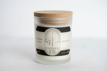 Candle with a wooden lid and label on a white background