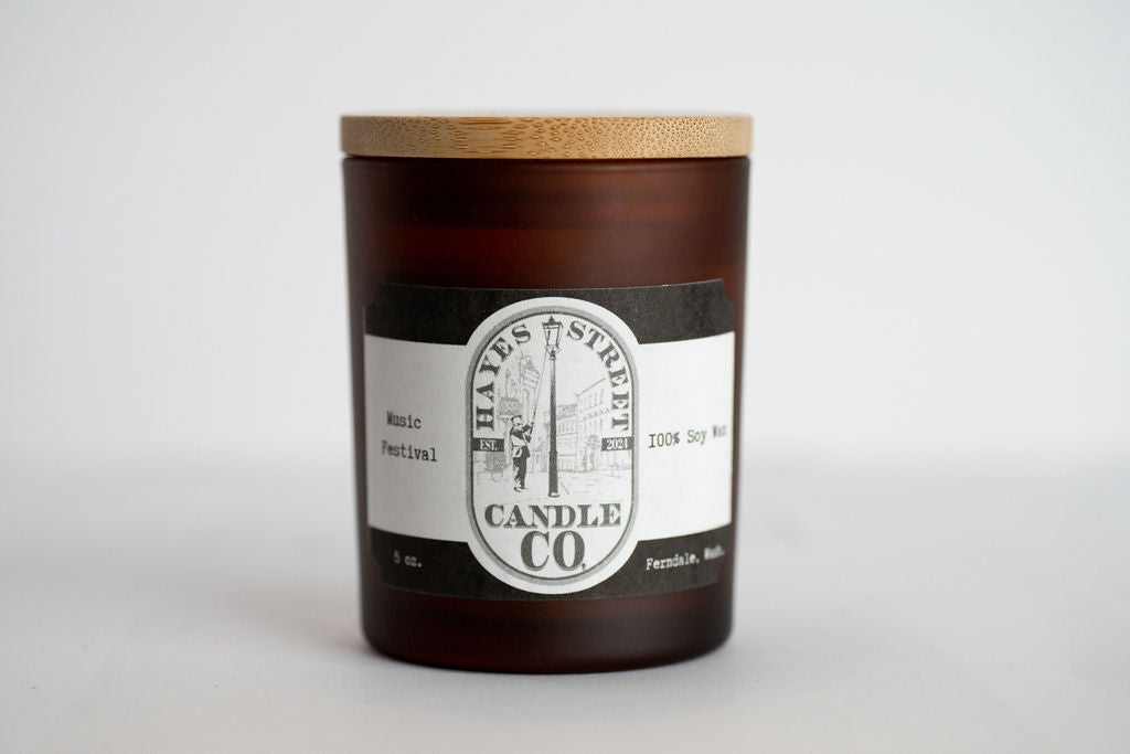 Candle with a wooden lid and label on a white background
